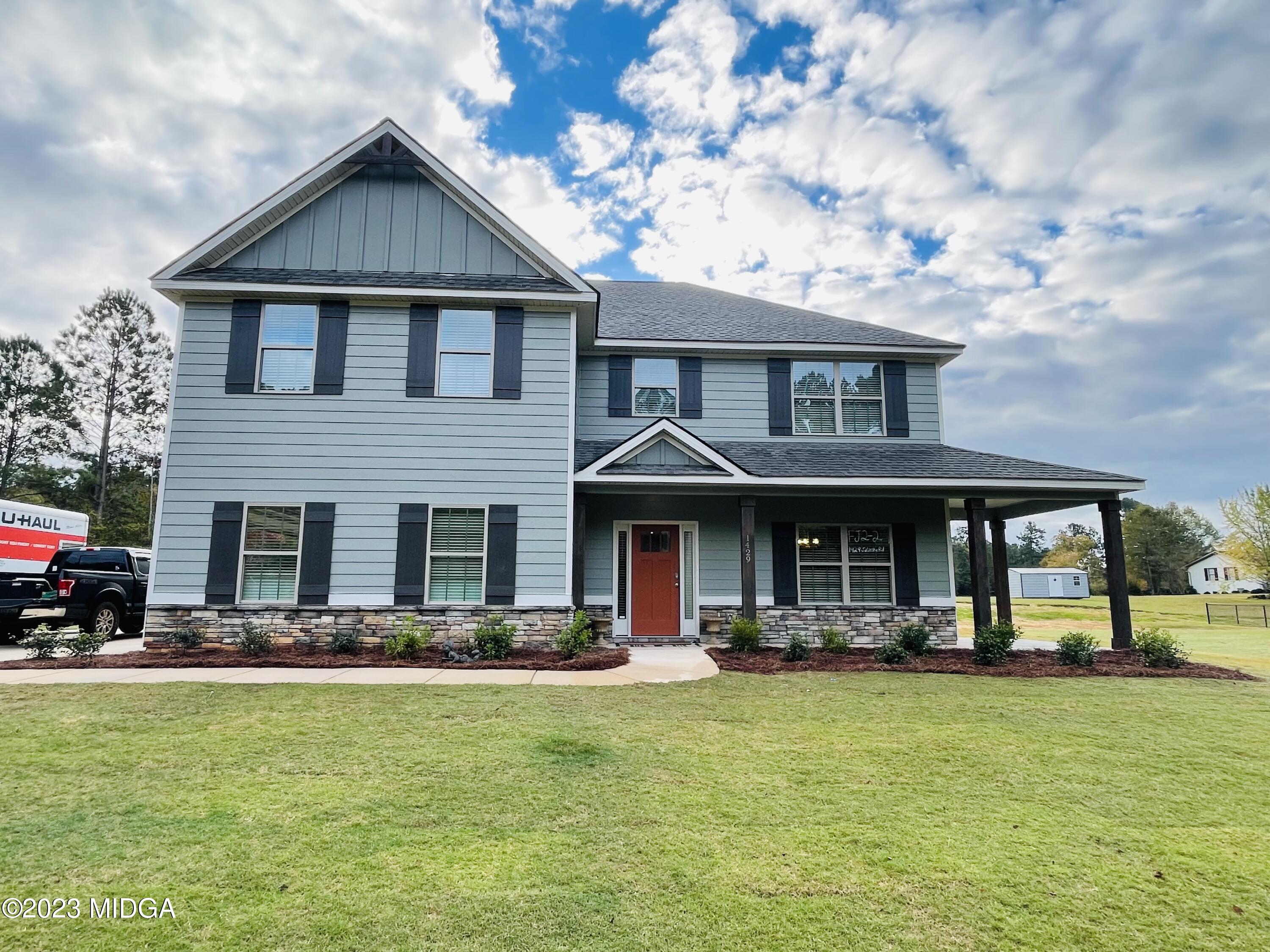1429 Juliette Road Forsyth, GA 31029 - Photo 1 of 1 a front view of a house with swimming pool having outdoor seating