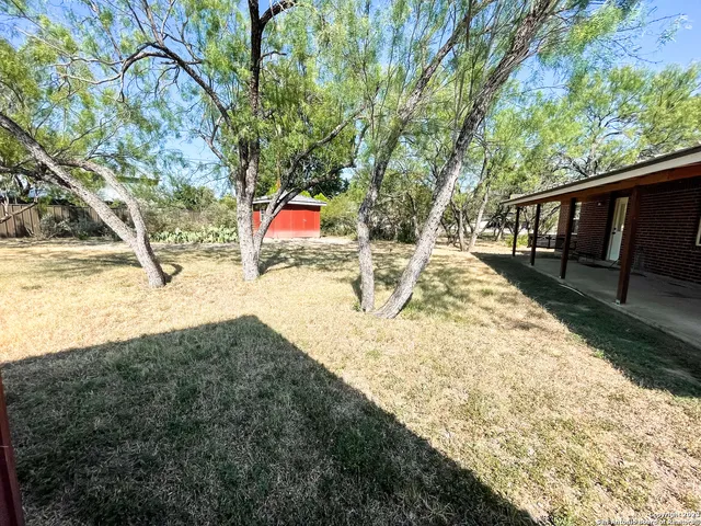 a view of backyard with large trees