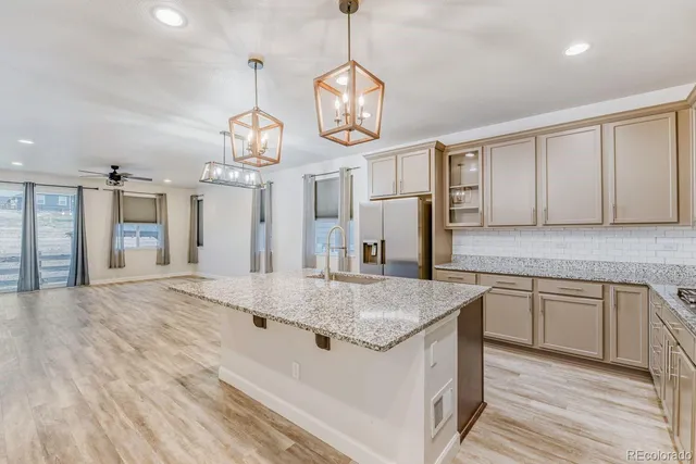 a kitchen with stainless steel appliances granite countertop stove top oven and cabinets