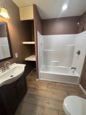 a bathroom with a sink mirror vanity and toilet