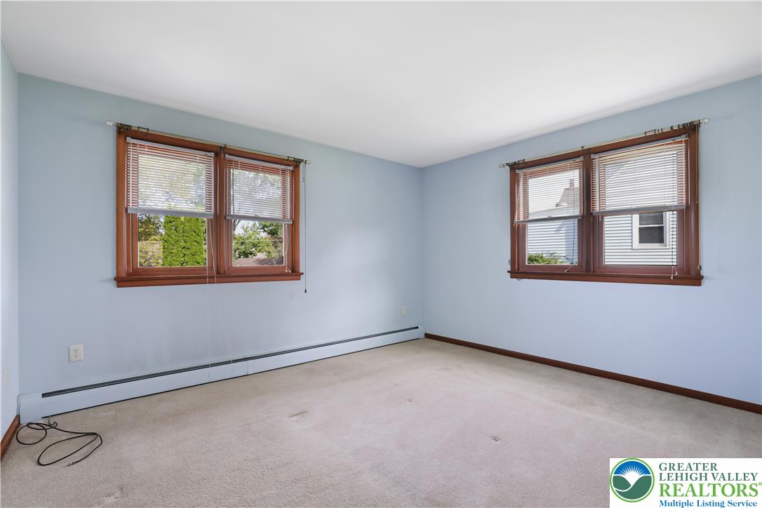 1539 Spring Garden Street Wilson, PA 18042 - Photo 14 of 34 Double wood-framed windows fill this carpeted room with natural light.