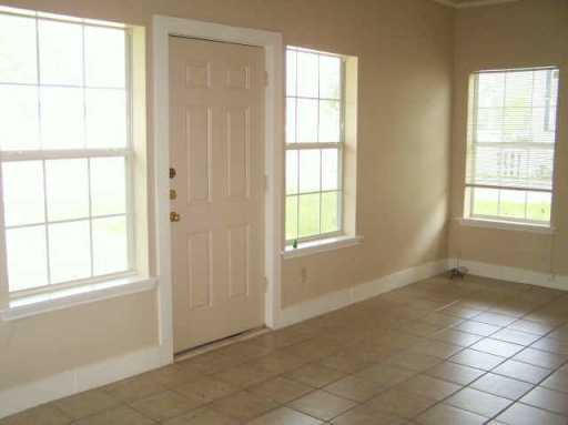 1609 Cedar Street Bastrop, TX 78602 - Photo 2 of 7 Entrance foyer featuring healthy amount of natural light and tile patterned flooring
