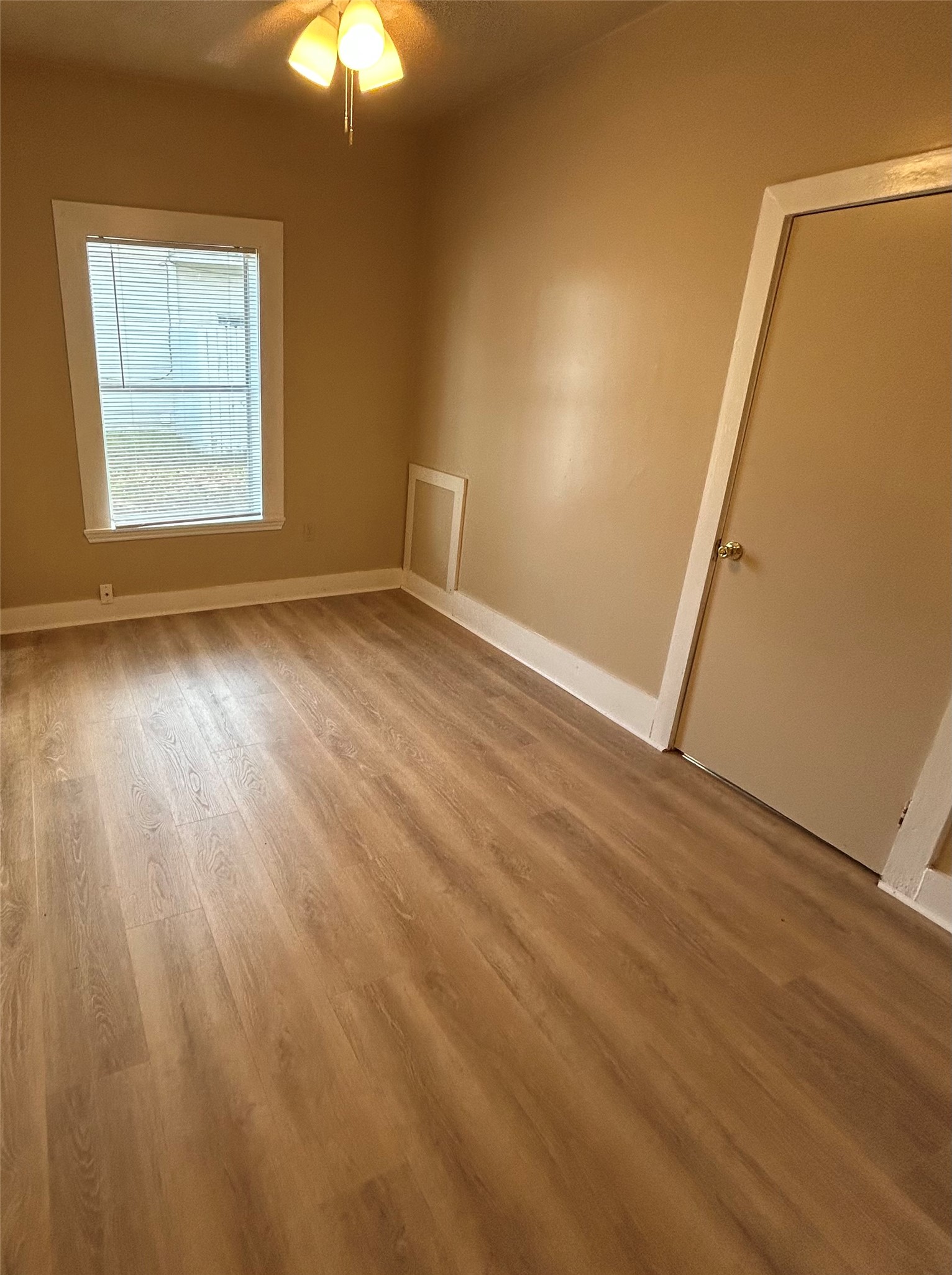 1609 Cedar Street Bastrop, TX 78602 - Photo 5 of 7 2nd Bedroom with light wood-style floors and a ceiling fan
