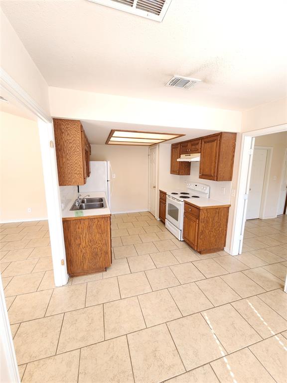 8811 Clearbrook Trail Austin, TX 78729 - Photo 8 of 38 lft A - Functional kitchen with ample cabinet space, perfect for everyday meal preparation.