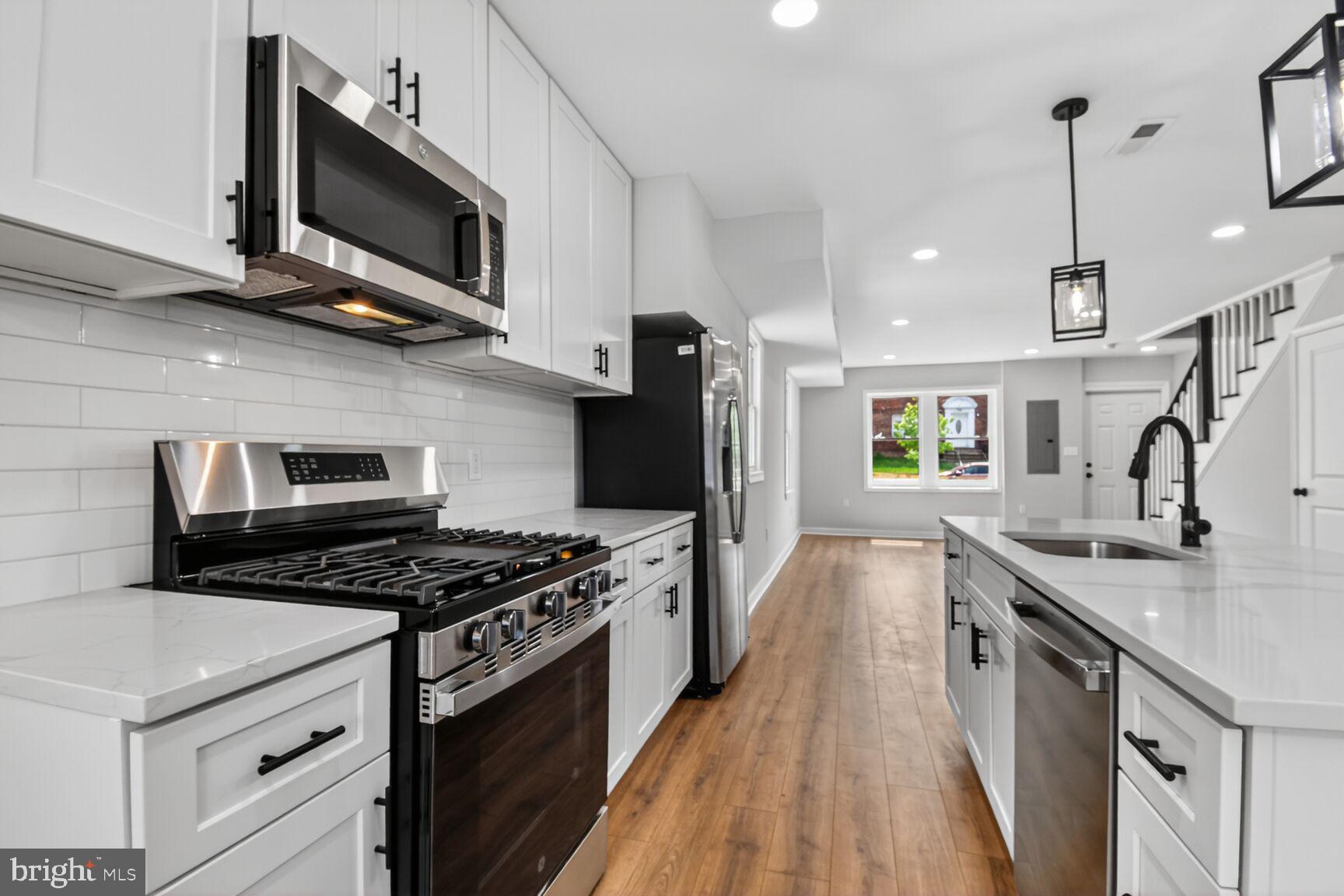305 Decatur Street Northwest Washington, DC 20011 - Photo 8 of 21 a kitchen with stainless steel appliances granite countertop a sink stove and microwave