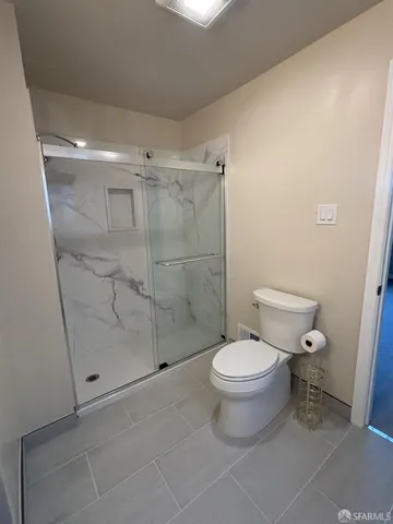 a white toilet sitting next to a bathroom sink