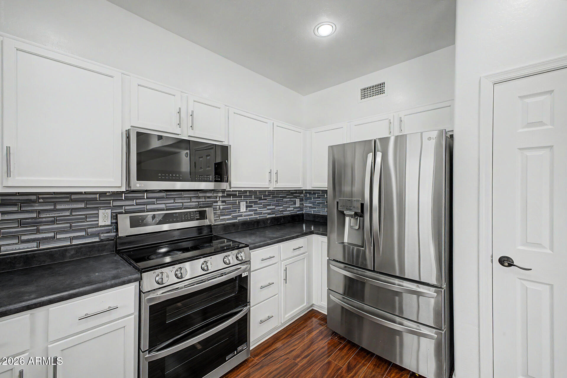 7206 South 12th Way Phoenix, AZ 85042 - Photo 12 of 34 a kitchen with a refrigerator stove and microwave