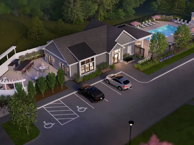 an aerial view of residential houses with outdoor space and city view