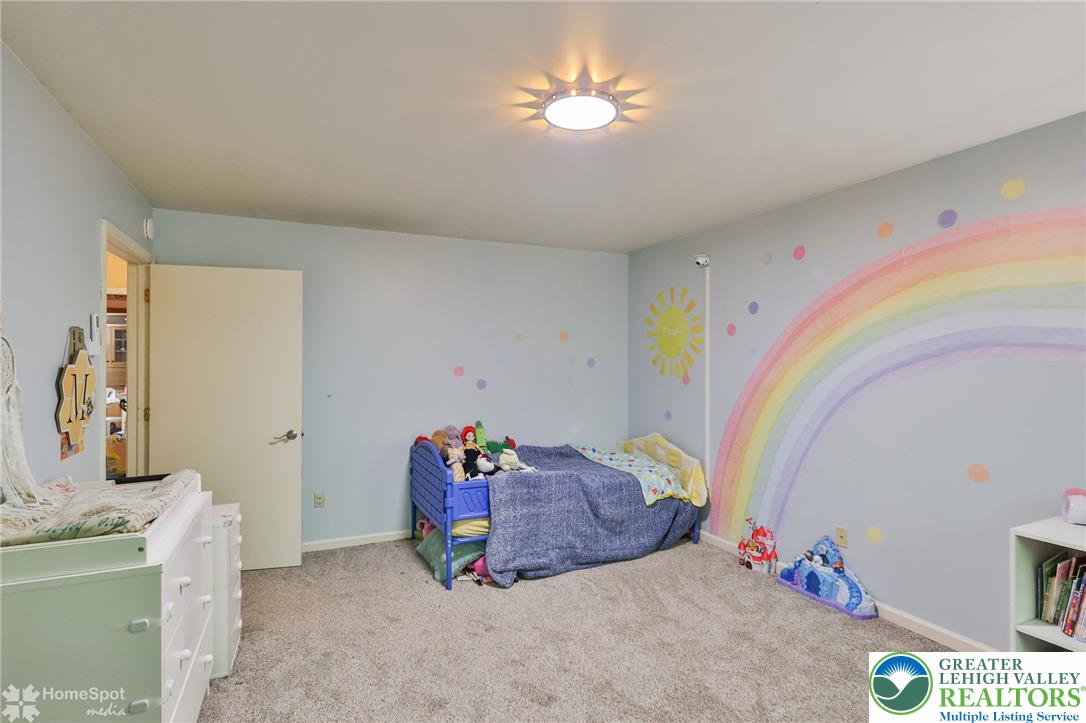 60 Sassafras Road Lehighton, PA 18235 - Photo 26 of 36 A cheerful children's bedroom featuring plush carpeting and a whimsical rainbow mural.