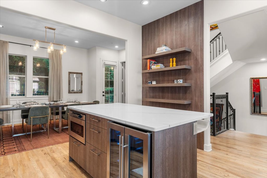 1529 Barton Springs Road, Unit 27 Austin, TX 78704 - Photo 37 of 40 A pristine kitchen island, complete with an integrated wine cooler, offers a seamless transition to the dining area.