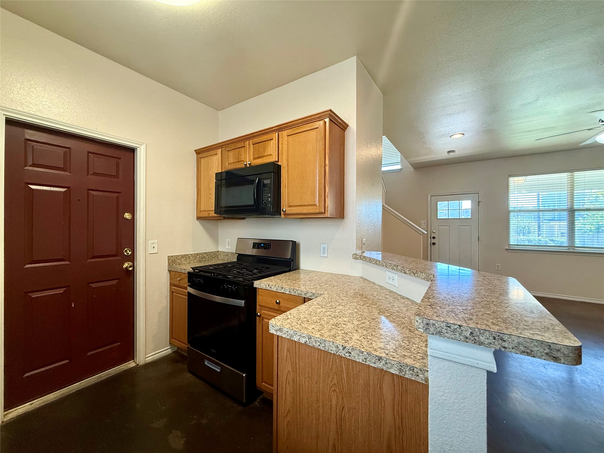 6912 Meador Avenue, Unit A Austin, TX 78752 - Photo 9 of 24 a kitchen with granite countertop counter top space cabinets and appliances