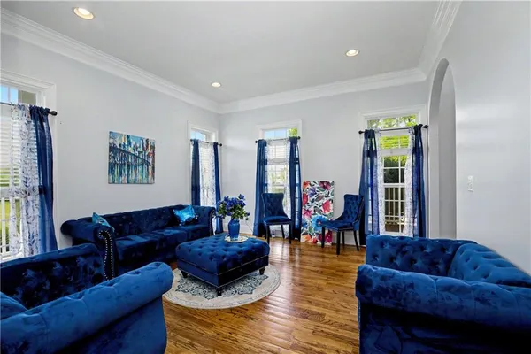 a large kitchen with stainless steel appliances granite countertop a lot of counter space and wooden floor