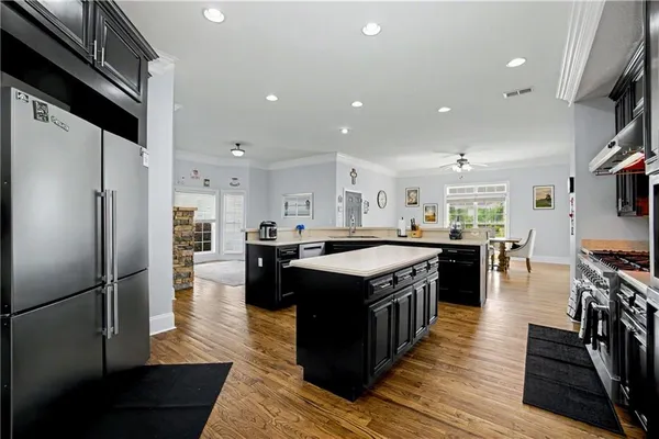 a view of a hallway with wooden floor and a bathroom