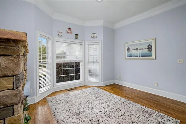 a spacious bedroom with a bed and a large window