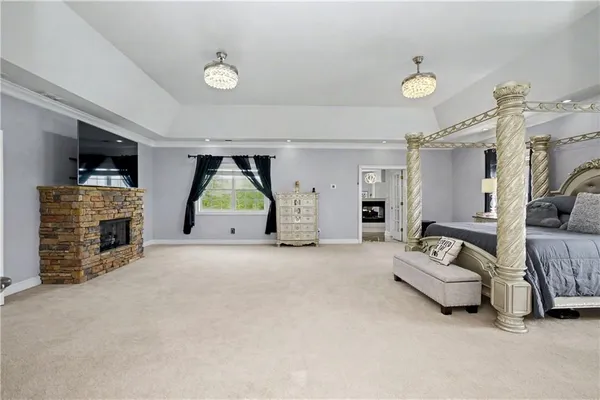 a living room with furniture a flat screen tv and a table