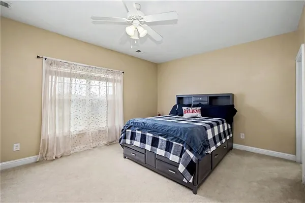an aerial view of a house with swimming pool a yard and lake view