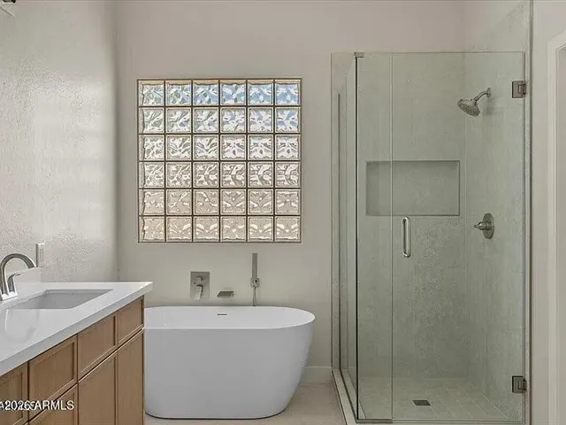 a bathroom with a bathtub and sink