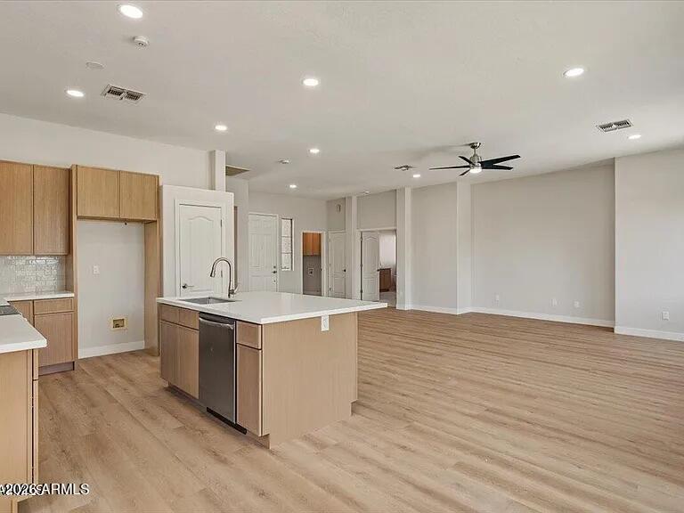 2918 East Harwell Road Gilbert, AZ 85234 - Photo 5 of 12 a large kitchen with stainless steel appliances a large counter top a sink and a refrigerator