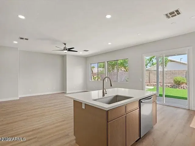 a kitchen with a sink and large window