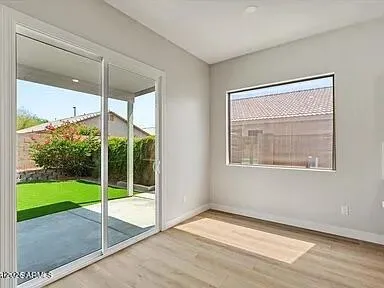 a view of an empty room with a window and a floor to ceiling window