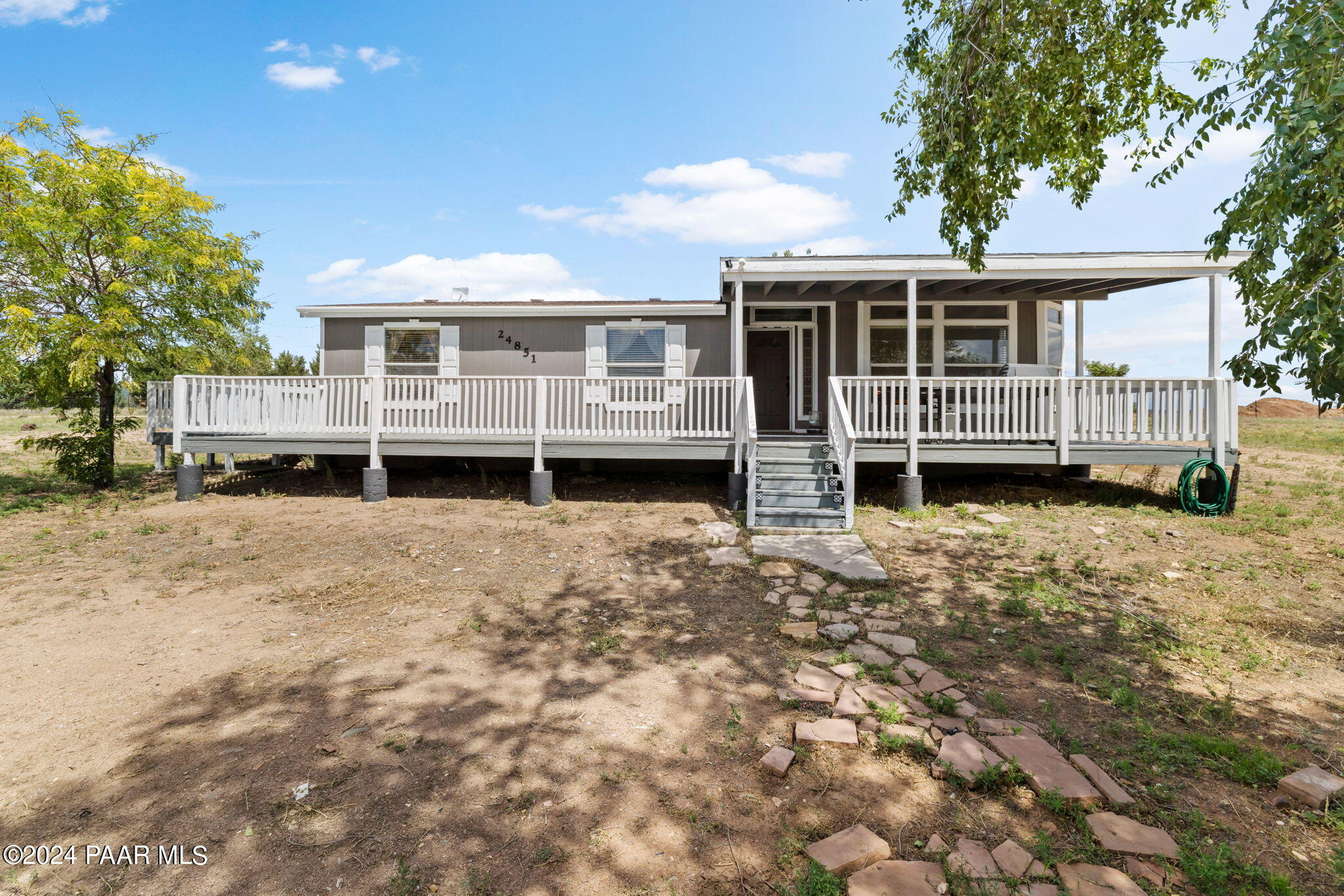 24851 North Mitchell Road Paulden, AZ 86334 - Photo 1 of 38 a front view of a house with a yard