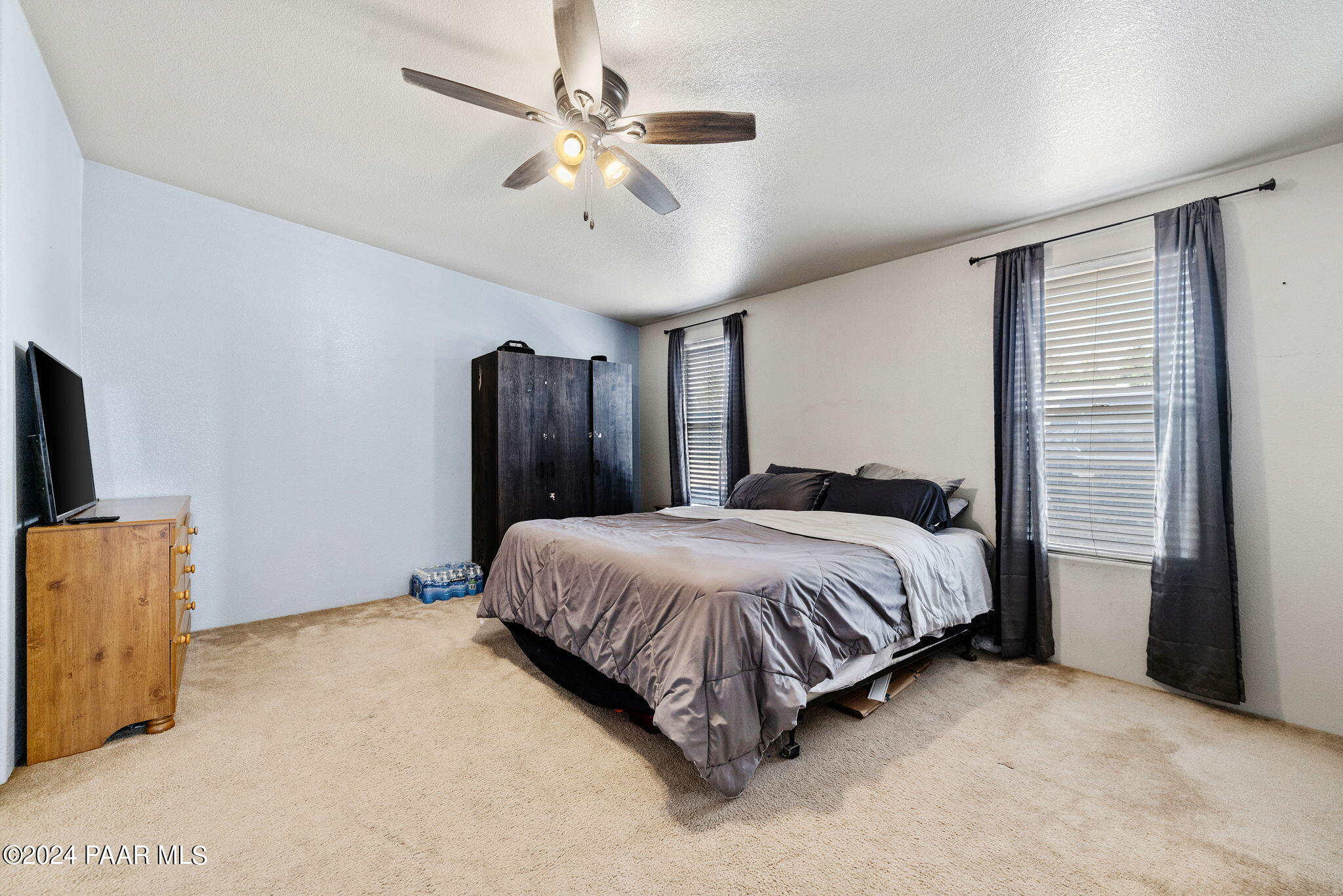 24851 North Mitchell Road Paulden, AZ 86334 - Photo 26 of 38 a spacious bedroom with a bed and a flat screen tv