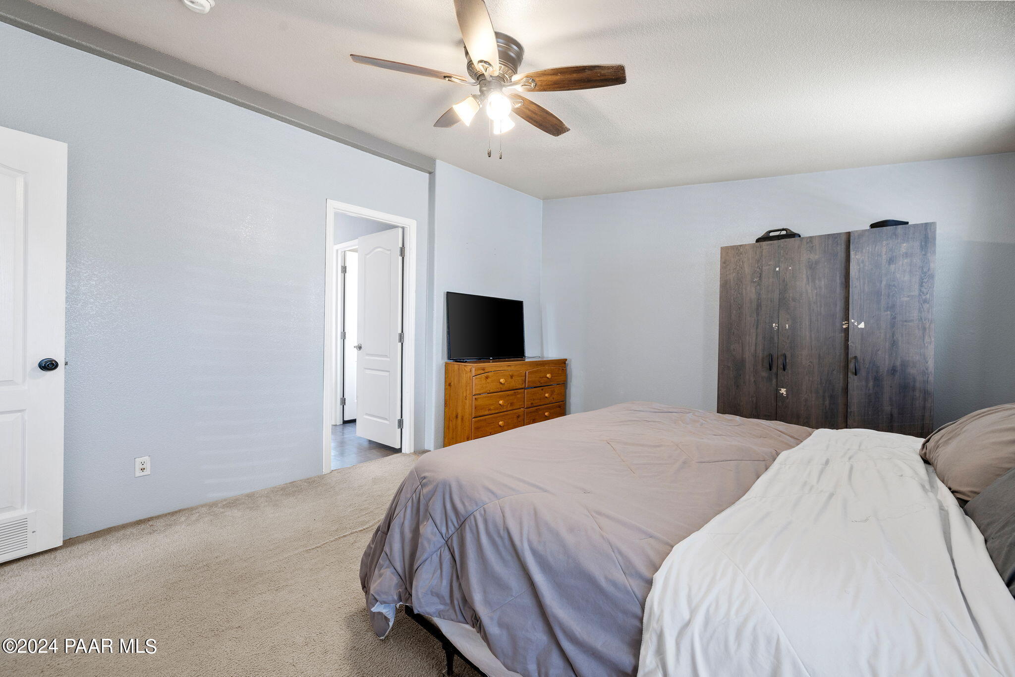 24851 North Mitchell Road Paulden, AZ 86334 - Photo 27 of 38 a bedroom with a bed and a chandelier