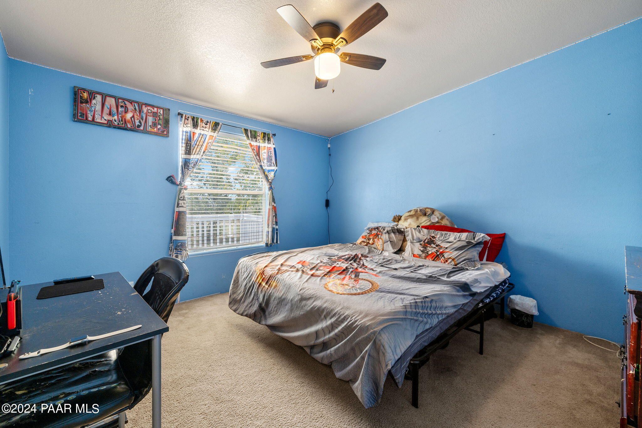 24851 North Mitchell Road Paulden, AZ 86334 - Photo 34 of 38 a bedroom with a bed and a chandelier