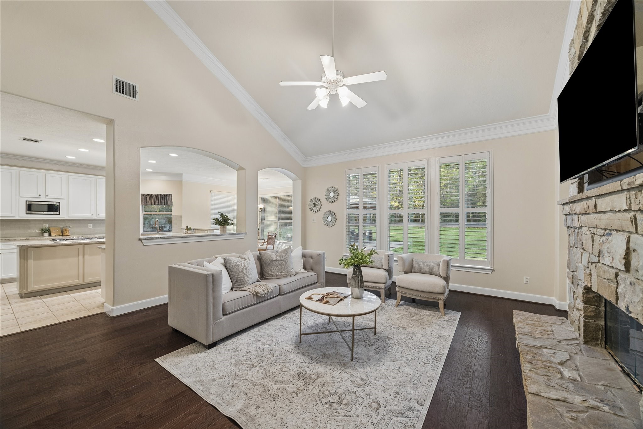 14530 Millhouse Road Pinehurst, TX 77362 - Photo 11 of 46 Light-filled living space with expansive windows overlooking the grounds, offering natural light and a comfortable, inviting atmosphere.