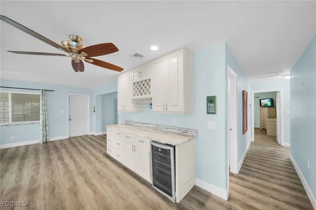 a kitchen with a stove and a wooden floors