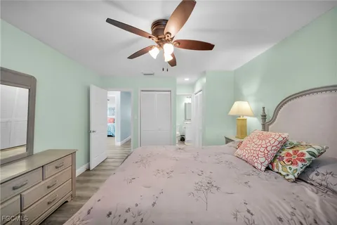 a bedroom with a large bed and a chandelier