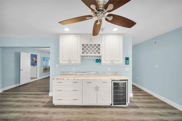 a kitchen with a stove cabinets and wooden floor