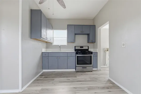 a kitchen with a refrigerator and a stove top oven