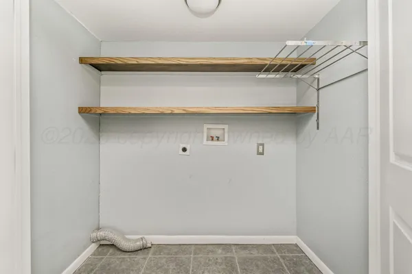 a view of walk in closet with clothes