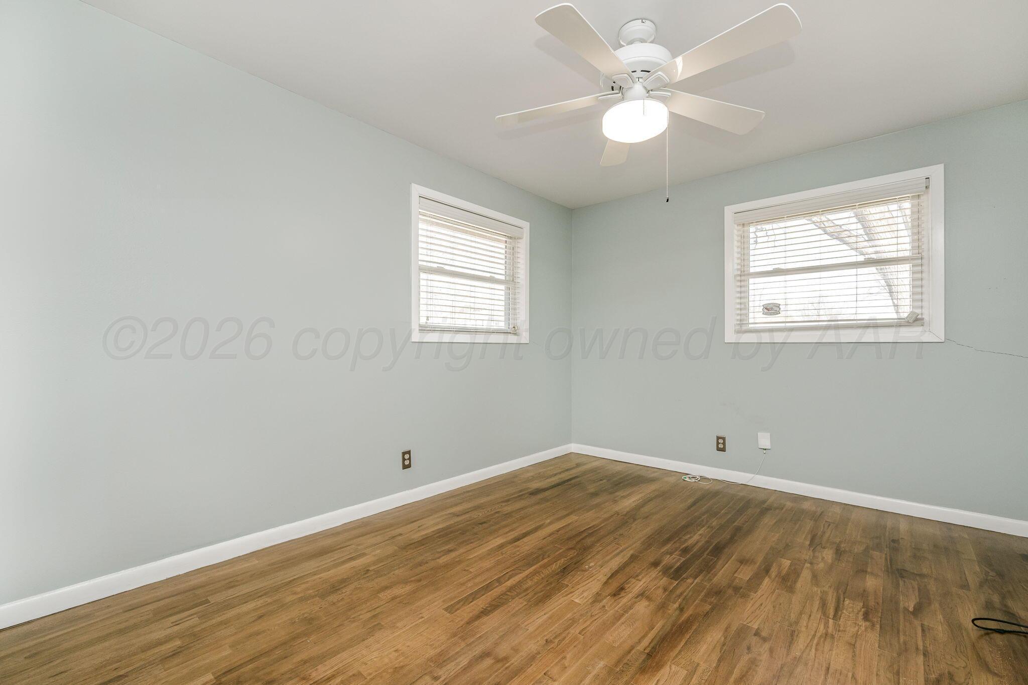4305 Omaha Avenue Amarillo, TX 79106 - Photo 14 of 20 wooden floor in an empty room with a window