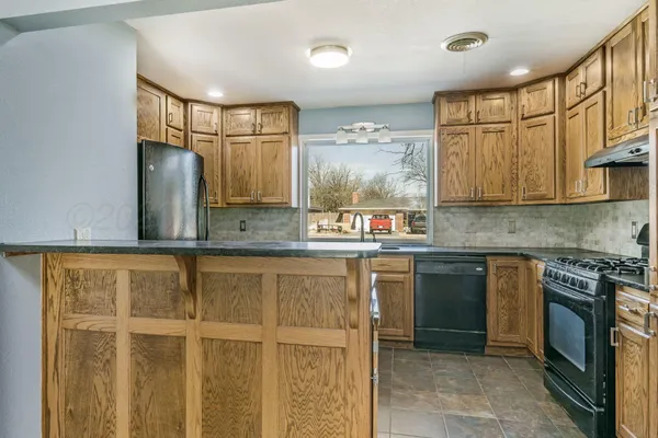 a kitchen with stainless steel appliances granite countertop a refrigerator and stove