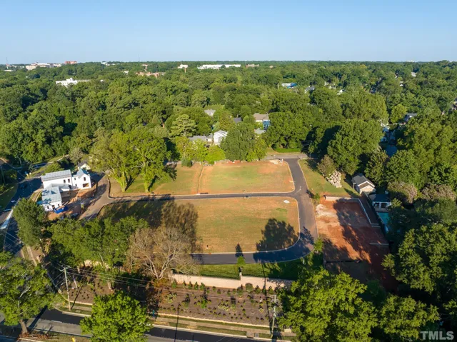 an aerial view of a residential houses with outdoor space