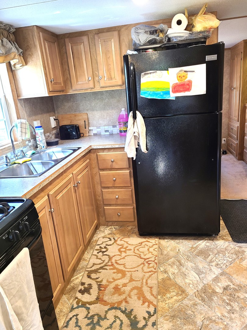 21-80 Woodhaven Sublette, IL 61367 - Photo 9 of 21 a kitchen with granite countertop a refrigerator and a stove