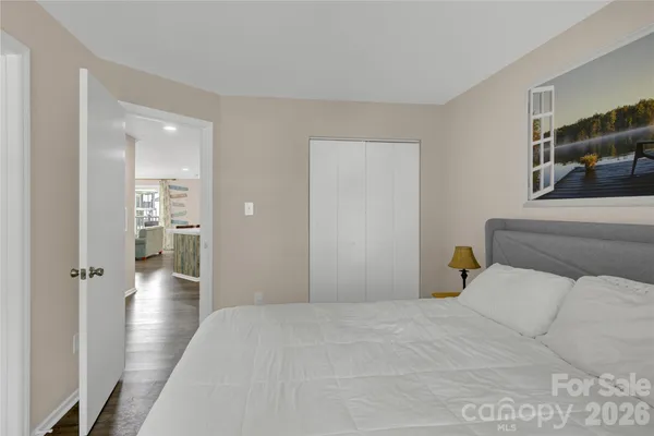 a bedroom with a bed and a chandelier