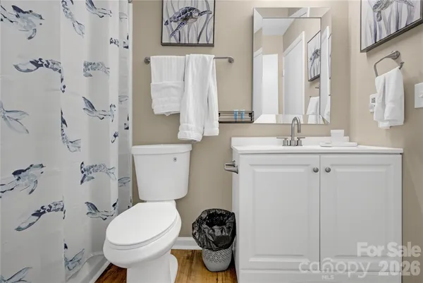 a bedroom with a bed and a flat tv screen on wall