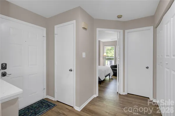 a balcony with chairs and a potted plant