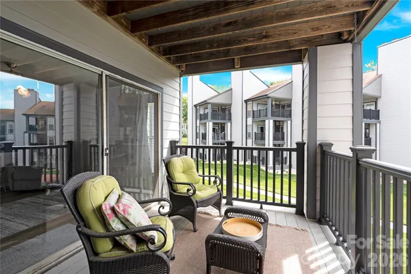 a view of a terrace with lawn chairs
