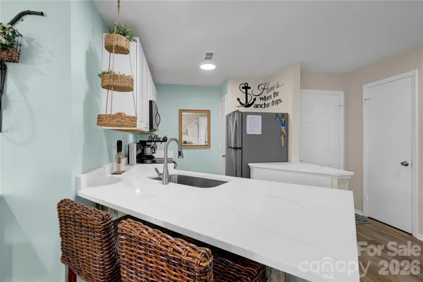 a living room with furniture and kitchen view