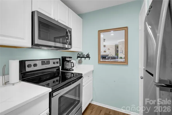 a living room with furniture a ceiling fan a fireplace and a large window