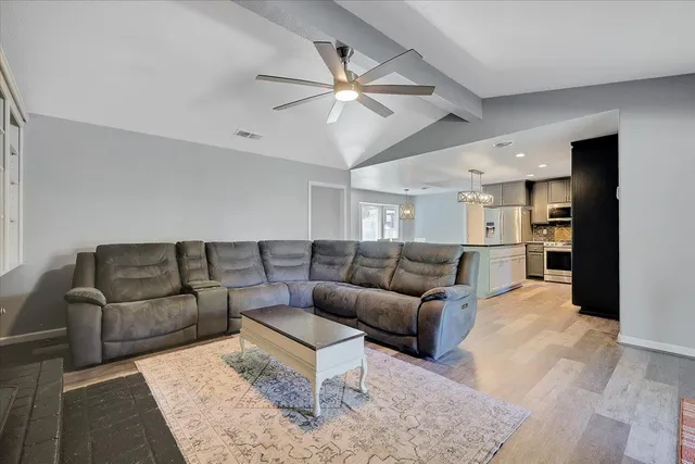 a living room with furniture and kitchen view