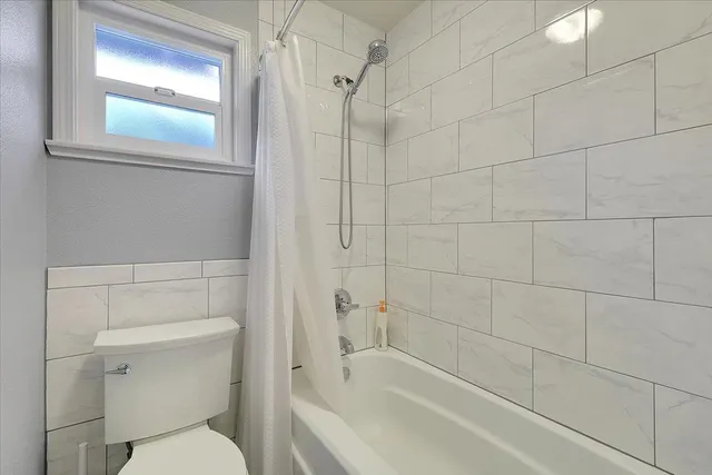 a bathroom with a toilet and a bathtub