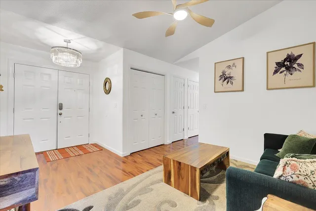 a living room with furniture and a chandelier