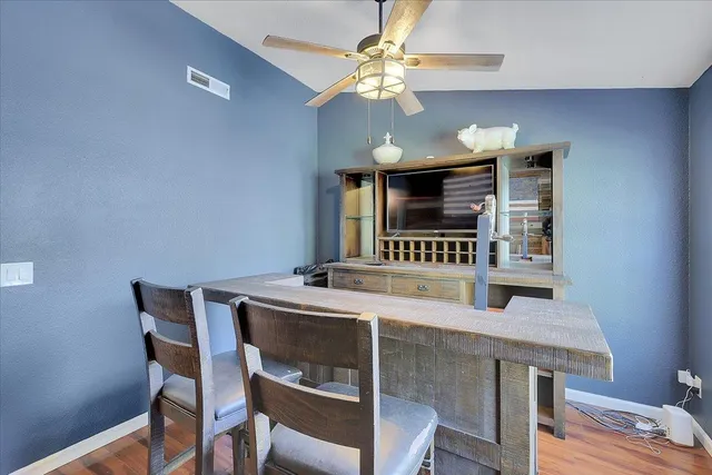 a view of a dining room with furniture and a chandelier