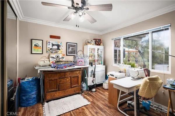 a view of a livingroom with furniture and a ceiling fan