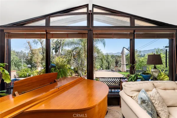 a bedroom with furniture and a large window